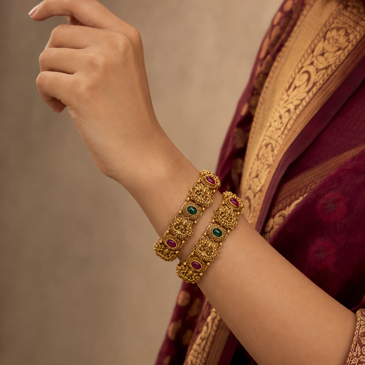 Indian woman wearing two Lakshmi temple bangles with alternating red and green stones
