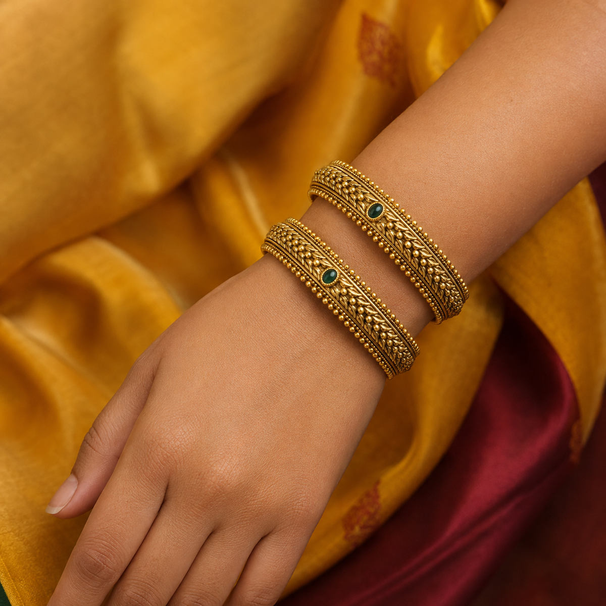 Indian woman wearing two green stone braided antique gold-tone bangles