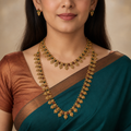 Close model view wearing both coin motif necklaces and tiny matching earrings