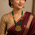 Close view of woman wearing emerald Lakshmi necklace set