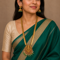 Close worn view of Lakshmi long necklace set with emerald saree